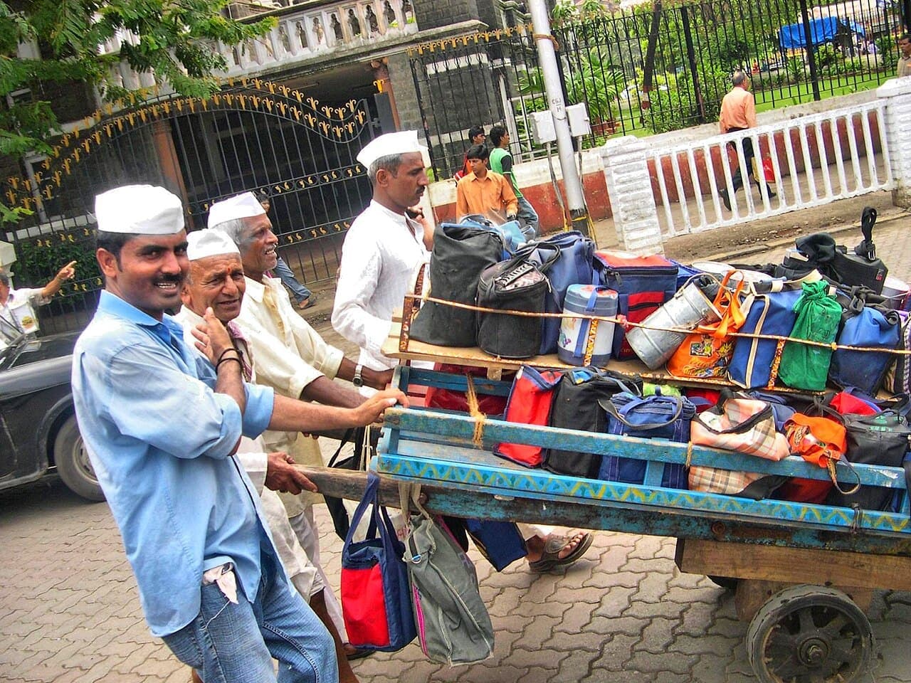 Mumbai dabbawalas with a cart of lunch tiffins